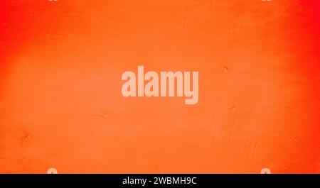 Old peeling paint on the wall. Red abstract background. Background from red stucco. Stock Photo