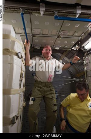 S133-E-007877 (1 March 2011) --- NASA astronaut Scott Kelly (left), Expedition 26 commander; and European Space Agency astronaut Paolo Nespoli, flight engineer, are pictured in the newly-installed Permanent Multipurpose Module (PMM) of the International Space Station while space shuttle Discovery (STS-133) remains docked with the station. Stock Photo