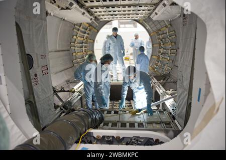 CAPE CANAVERAL, Fla. -- In the Space Station Processing Facility at NASA's Kennedy Space Center in Florida, the STS-135 crew inspects the Raffaello multi-purpose logistics module with the carrier's technician. From left are Pilot Doug Hurley, Mission Specialist Sandy Magnus, Commander Chris Ferguson (upper level), a carrier technician and Mission Specialist Rex Walheim. The four-member crew is at Kennedy participating in the Crew Equipment Interface Test (CEIT), which gives them an opportunity for hands-on training with tools they'll use in space and familiarization of the payload they'll deli Stock Photo