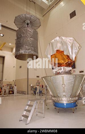 An overhead crane lifts the cylindrical canister toward the Mars Odyssey orbiter. The canister will be lowered over the spacecraft to protect it during transfer to Launch Pad 17-A, Cape Canaveral Air Force Station. The Mars Odyssey is scheduled for launch at 11 02 a.m. EDT April 7, 2001, aboard a Delta II rocket from Pad 17-A. The spacecraft will map the Martian surface in search of geological features that could indicate the presence of water, now or in the past, and may contribute significantly toward understanding what will be necessary for a more sophisticated exploration of Mars Stock Photo