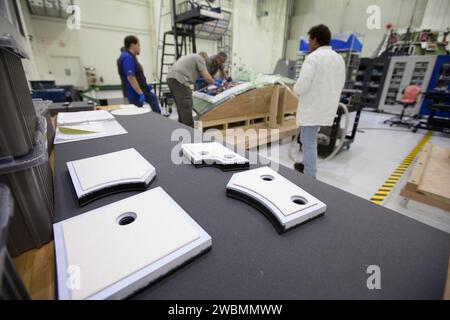 At Kennedy Space Center in Florida, technicians bond thermal protection system tiles to Orion's backshell panels on July 8, 2016...While similar to those used on the space shuttle, Orion only requires about 1,300 tiles compared to more than 24,000 on the shuttle. The tiles, along with the spacecraft’s heat shield, will protect Orion from the 5,000 degree Fahrenheit heat of re-entry. Stock Photo