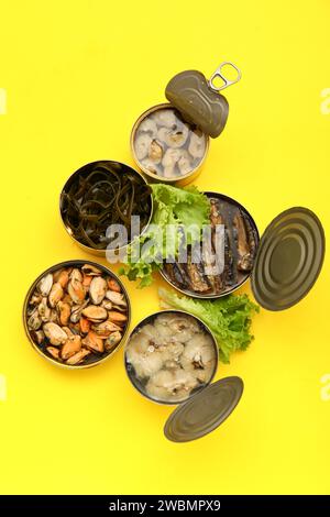 Assortment of canned seafood. Tin cans with preserved products, garlic ...