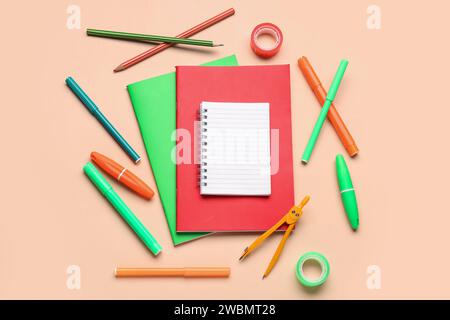 Notebooks with different stationery on pale orange background Stock Photo