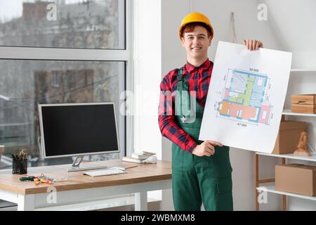 Male electrician with house plan in room Stock Photo