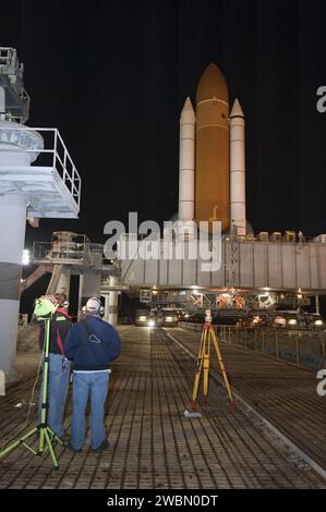 CAPE CANAVERAL, Fla. -- Workers monitor space shuttle Discovery as it arrives at Launch Pad 39A from the Vehicle Assembly Building at NASA's Kennedy Space Center in Florida. It took the shuttle, attached to its external fuel tank, twin solid rocket boosters and mobile launcher platform, about seven hours to complete the move atop a crawler-transporter. This is the second time Discovery has rolled out to the pad for the STS-133 mission, and comes after a thorough check and modifications to the shuttle's external tank.       Targeted to liftoff Feb. 24, Discovery will take the Permanent Multipur Stock Photo