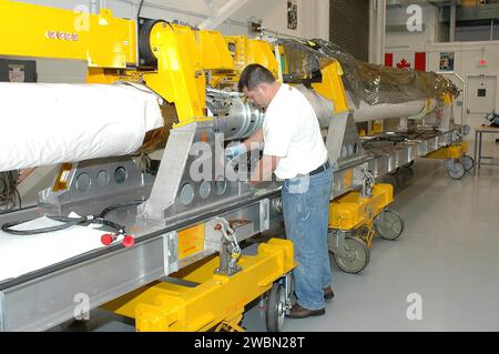 Technician Jake Senior prepares the Orbiter Boom Sensor System in the Remote Manipulator System lab for final testing before installation on Space Shuttle Discovery to inspect the Thermal Protection System during STS-114 Return to Flight. Stock Photo
