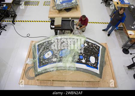 At Kennedy Space Center in Florida, technicians bond thermal protection system tiles to Orion's backshell panels on July 8, 2016...While similar to those used on the space shuttle, Orion only requires about 1,300 tiles compared to more than 24,000 on the shuttle. The tiles, along with the spacecraft’s heat shield, will protect Orion from the 5,000 degree Fahrenheit heat of re-entry. Stock Photo