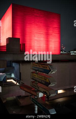 Iluminated red National Theatre bankside, Southbank, central London, England. Stock Photo