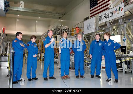 KENNEDY SPACE CENTER, FLA. - After looking over some of the hardware in the Space Station Processing Facility, STS-114 crew members answer questions from the media. From right are Mission Specialists Charles Camarda, Wendy Lawrence, Stephen Robinson (with the microphone), Soichi Noguchi (with the Japanese Space Agency) and Andrew Thomas; Pilot James Kelly; and Commander Eileen Collins. They are standing in front of the Multi-Purpose Logistics Module Raffaello that will fly on mission STS-114. The crew is at KSC for Crew Equipment Interface Test (CEIT) activities. During CEIT, the crew has an o Stock Photo