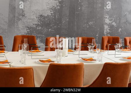 Stylish festive table setting in a restaurant, banquet hall. Wedding, celebration, banquet. Stock Photo
