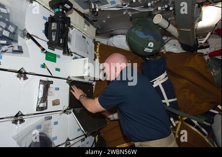 S134-E-007765 (20 May 2011) --- NASA astronaut Mark Kelly, STS-134 commander, works on the middeck of space shuttle Endeavour while docked with the International Space Station. Stock Photo