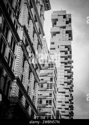 New-Yok, USA, 16 November 2023; View of a modern skyscraper designed by architect Pavel Bendov, with the facade of an old building in the contrasting Stock Photo