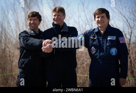 Expedition 19 Flight Engineer Michael R. Barratt, left, Commander Gennady I. Padalka, center, and Spaceflight Participant Charles Simonyi pose for a photograph after the traditional tree planting ceremony at the Cosmonaut Hotel, Saturday, March 21, 2009 in Baikonur, Kazakhstan. Stock Photo