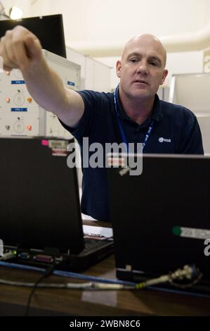 ESA astronaut Andre Kuipers of Expedition 30 trains near the Columbia module at SSTF with trainer Michaela Benda using laptops on September 1, 2011. Stock Photo