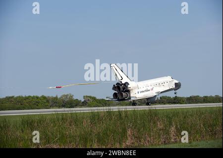 Space Shuttle Discovery deploys its drag chute as the vehicle comes to ...