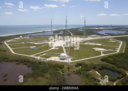 CAPE CANAVERAL, Fla. – An aerial view, from the west looking toward the east, shows the entire Launch Pad 39B area at NASA’s Kennedy Space Center in Florida. A new elevator has been constructed on the surface of the pad and the crawlerway leading up to the surface is being repaired. Repairs also are being made to the crawler track panels and catacomb roof below on either side of the flame trench. Also in view are the water tower and the three tall lightning towers that surround the pad. To the east is the Atlantic Ocean. Upgrades are underway at Pad B and other facilities in the Launch Complex Stock Photo