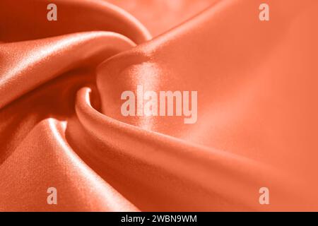 Peach Fuzz Silk Fabric with Copy Space. Color of the year 2024, Backdrop, Peach Fuzz Background, Peach Fuzz Design Backdrop. Stock Photo