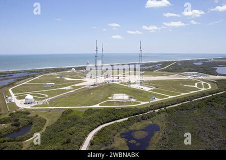 CAPE CANAVERAL, Fla. – An aerial view, from the west looking toward the east, shows the entire Launch Pad 39B area at NASA’s Kennedy Space Center in Florida. A new elevator has been constructed on the surface of the pad and the crawlerway leading up to the surface is being repaired. Repairs also are being made to the crawler track panels and catacomb roof below on either side of the flame trench. Also in view are the water tower and the three tall lightning towers that surround the pad. To the east is the Atlantic Ocean. Upgrades are underway at Pad B and other facilities in the Launch Complex Stock Photo