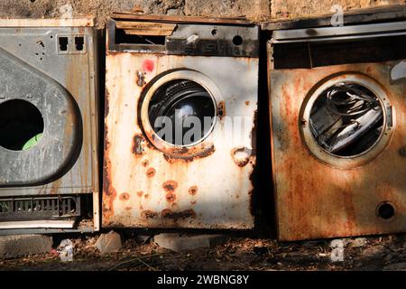 Abandoned rusty washing machines in nature. Stock Photo