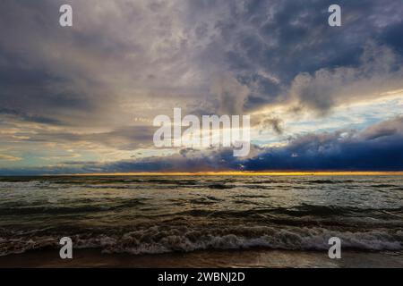 Sunset or dawn on sea. Dramatic cloudy sky. Stock Photo
