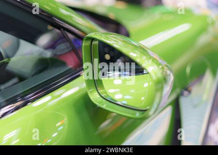 close-up shot showcasing the sleek blue side mirror of a modern car reflective surface and streamlined design exude contemporary style, embodying the Stock Photo