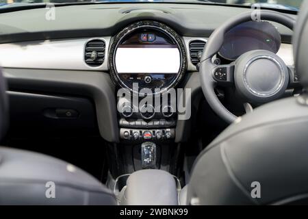 White mockup of a digital display screen on the dashboard of a modern car. This scene embodies innovation, promising a seamless blend of functionality Stock Photo