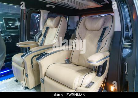 Interior of a luxury minivan, adorned with plush leather seats. Each seat exudes comfort and sophistication, creating an ambiance of indulgence for di Stock Photo