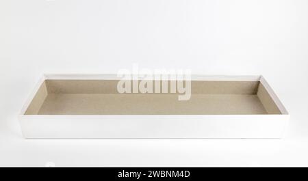 An empty rectangular white cardboard box. Layout for design and advertising. Gift box on a white background. Stock Photo