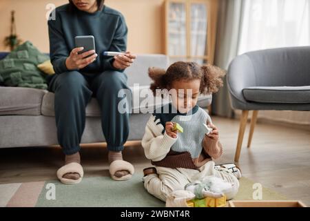 Sick Preschool Girl with Toys Staying at Home Stock Photo