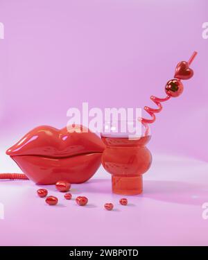 A Red Lip Shaped Phone and a Red Cocktail Beverage with a Disco Ball Drinking Straw and Red Hearts on a Pastel Pink Background Stock Photo