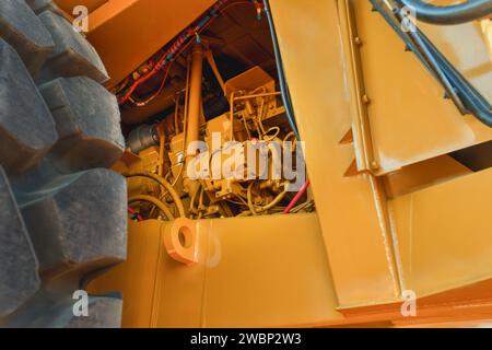 close up engine yellow mining truck and huge tire Stock Photo