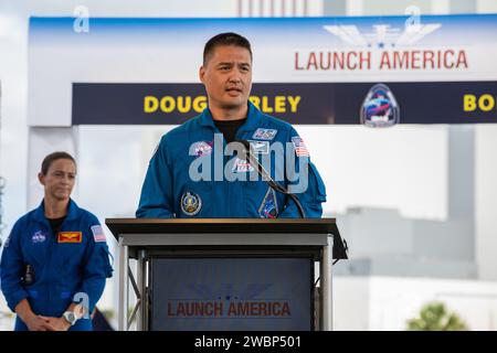 NASA astronaut Kjell Lindgren speaks to members of the media during a press briefing May 29, 2020, near the Press Site countdown clock at the agency’s Kennedy Space Center in Florida ahead of NASA’s SpaceX Demo-2 launch. Behind him is NASA astronaut Nicole Mann. The launch, initially scheduled for May 27, was scrubbed due to unfavorable weather conditions. The next launch attempt is Saturday, May 30. A SpaceX Falcon 9 rocket and Crew Dragon spacecraft are scheduled to lift off from Kennedy’s Launch Complex 39A, carrying NASA astronauts Robert Behnken and Douglas Hurley to the International Spa Stock Photo