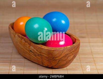 Colorful chicken eggs in a wooden bowl Stock Photo