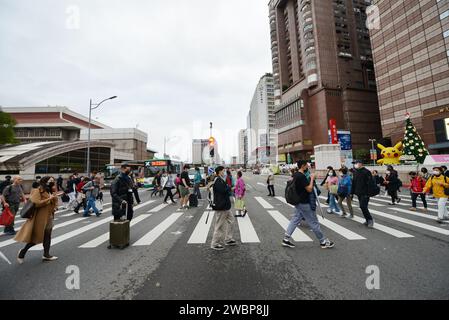 Pedestrians crossing the road opposite the Taipei Main station in Taipei, Taiwan. Stock Photo