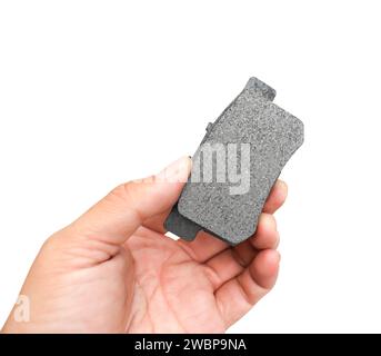 New car brake pads in the hands of a mechanic isolated on white background include clipping path , Car spare parts and maintenance concept Stock Photo