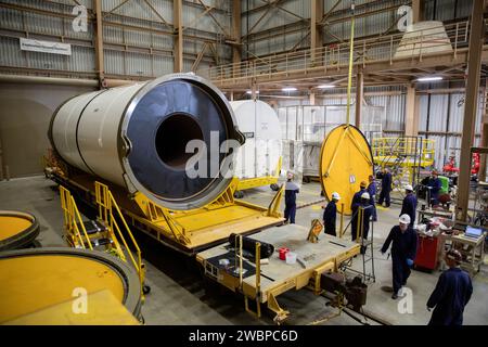 Engineers and technicians process and inspect the propellant of the right forward center segment of the Space Launch System solid rocket boosters for the Artemis II mission inside the Rotation, Processing and Surge Facility (RPSF) at NASA’s Kennedy Space Center in Florida on Monday, Nov. 27, 2023. Since arriving via rail in September, the team has been examining each segment one-by-one to make sure they are ready for integration and launch before being moved to the Vehicle Assembly Building for stacking atop the mobile launcher. Artemis II astronauts Reid Wiseman, Victor Glover, Christina Koch Stock Photo