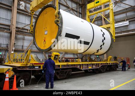 Engineers and technicians process the right forward center segment of the Space Launch System solid rocket boosters for the Artemis II mission inside the Rotation, Processing and Surge Facility (RPSF) at NASA’s Kennedy Space Center in Florida on Tuesday, Nov. 27, 2023.   The team has been examining the 10 booster segments one-by-one then lifting them to make sure they are ready for integration and launch before moving them to the Vehicle Assembly Building for stacking atop the mobile launcher. Artemis II astronauts Reid Wiseman, Victor Glover, Christina Koch, and Jeremy Hansen will blast off f Stock Photo