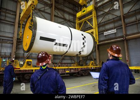 Engineers and technicians process the right forward center segment of the Space Launch System solid rocket boosters for the Artemis II mission inside the Rotation, Processing and Surge Facility (RPSF) at NASA’s Kennedy Space Center in Florida on Tuesday, Nov. 27, 2023.   The team has been examining the 10 booster segments one-by-one then lifting them to make sure they are ready for integration and launch before moving them to the Vehicle Assembly Building for stacking atop the mobile launcher. Artemis II astronauts Reid Wiseman, Victor Glover, Christina Koch, and Jeremy Hansen will blast off f Stock Photo