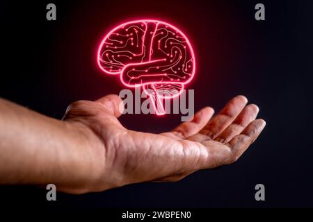 Hand and glowing brain shaped circuit board on black background. Artificial intelligence concept. Stock Photo