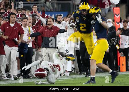 Michigan Wolverines running back Blake Corum (2) as his teammate Michigan Wolverines wide receiver Roman Wilson (1) clips Alabama Crimson Tide defensive back Terrion Arnold (3) and Alabama Crimson Tide head coach Nick Saban reacts to the foul in the 2024 Rose Bowl college Football playoff semifinal game against Alabama Crimson Tide. Michigan defeated Alabama 27-20 in overtime on Jan 1, 2024; Pasadena, CA, USA;  (Ed Ruvalcaba/Image of Sport) Stock Photo