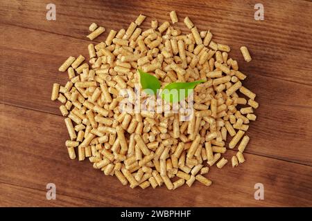 Heap of wooden pellets biofuel on wooden table Stock Photo