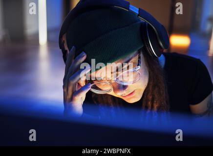 Hacker, problem and woman with a computer for cyber security, stress headache and reading information at night. Tired, error and hacker with Stock Photo