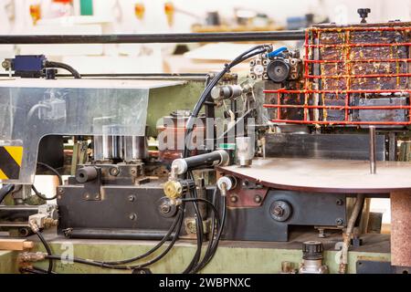 glue machine working in the factory plant for furniture, carpenter workshop gluing wood Stock Photo