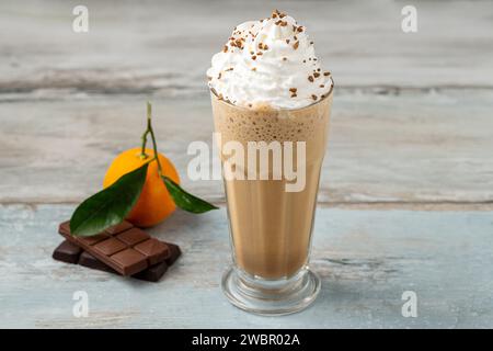 Orange and chocolate milkshake with coffee sprinkled on top Stock Photo