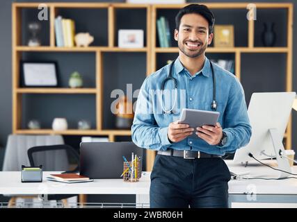 Smile, tablet and portrait of doctor in office using the internet or web for medical search online, confident and satisfied. Man healthcare Stock Photo