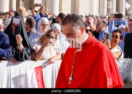 New cardinal Angel Fernandez Artime walks past Pope Francis during a