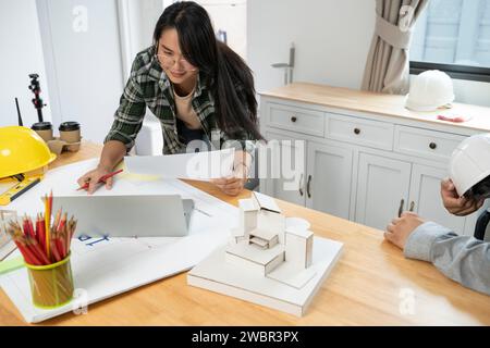 young female engineer making blueprints. Stock Photo