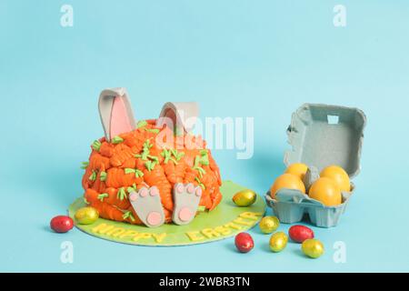 Carrot covered Easter bunny cake, happy Easter concept Stock Photo
