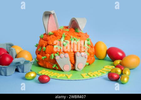 Carrot covered Easter bunny cake, happy Easter concept Stock Photo