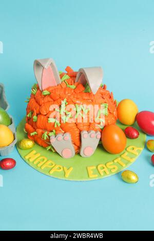 Carrot covered Easter bunny cake, happy Easter concept Stock Photo